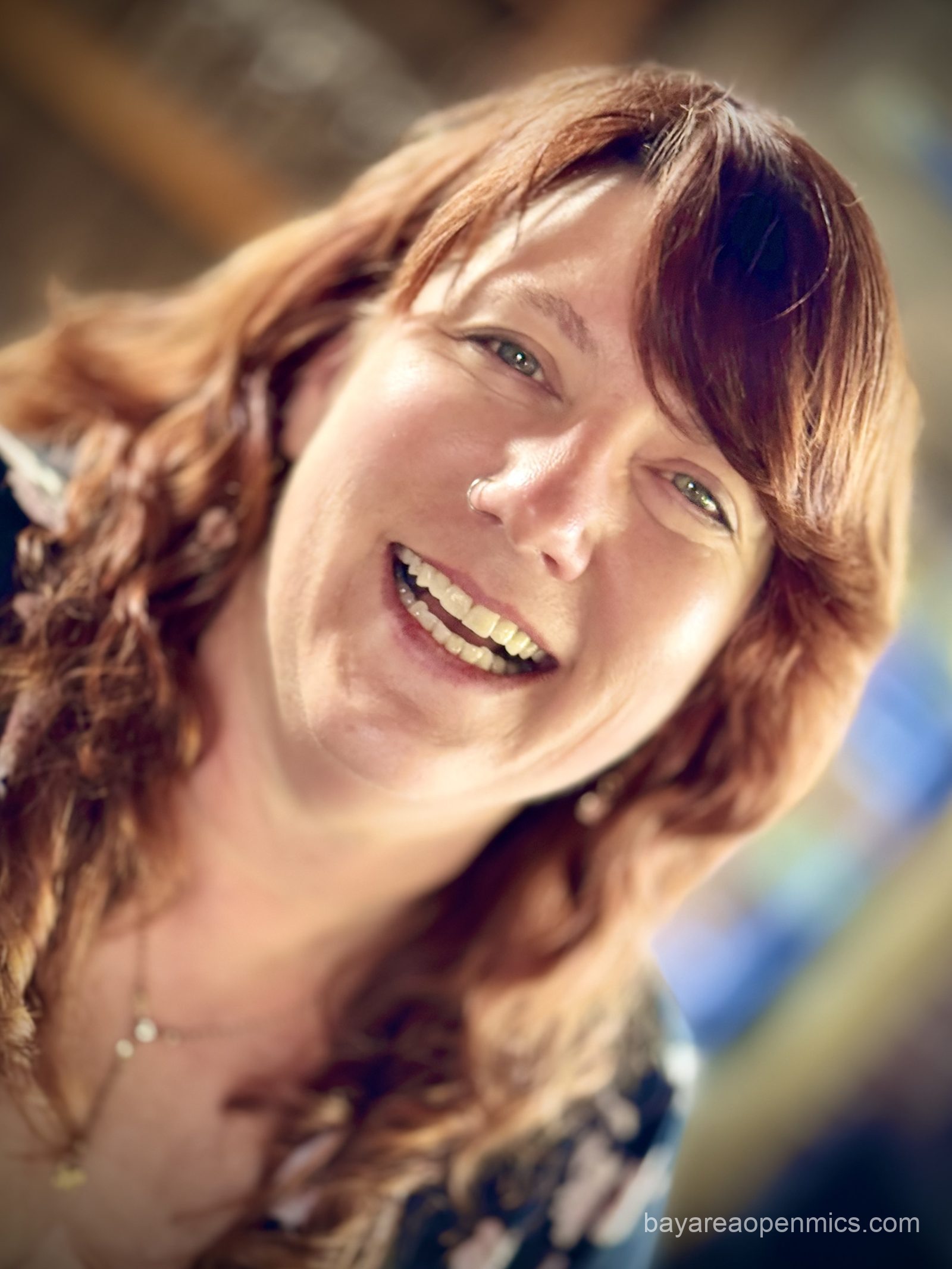 a beautiful red-haired woman smiles into the camera