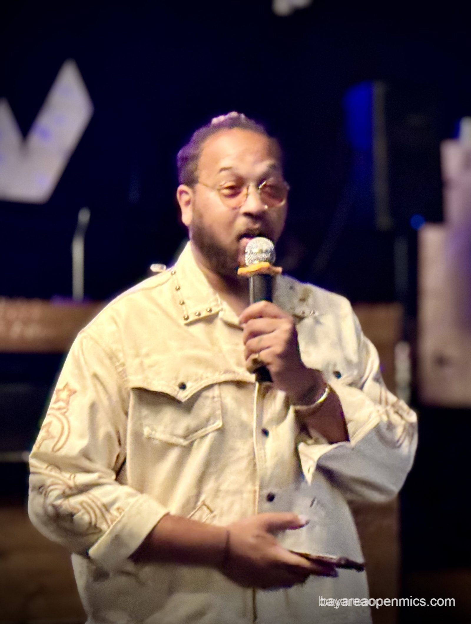 Muzik Ra performs an improvised song at the Fluid open mic in West Oakland