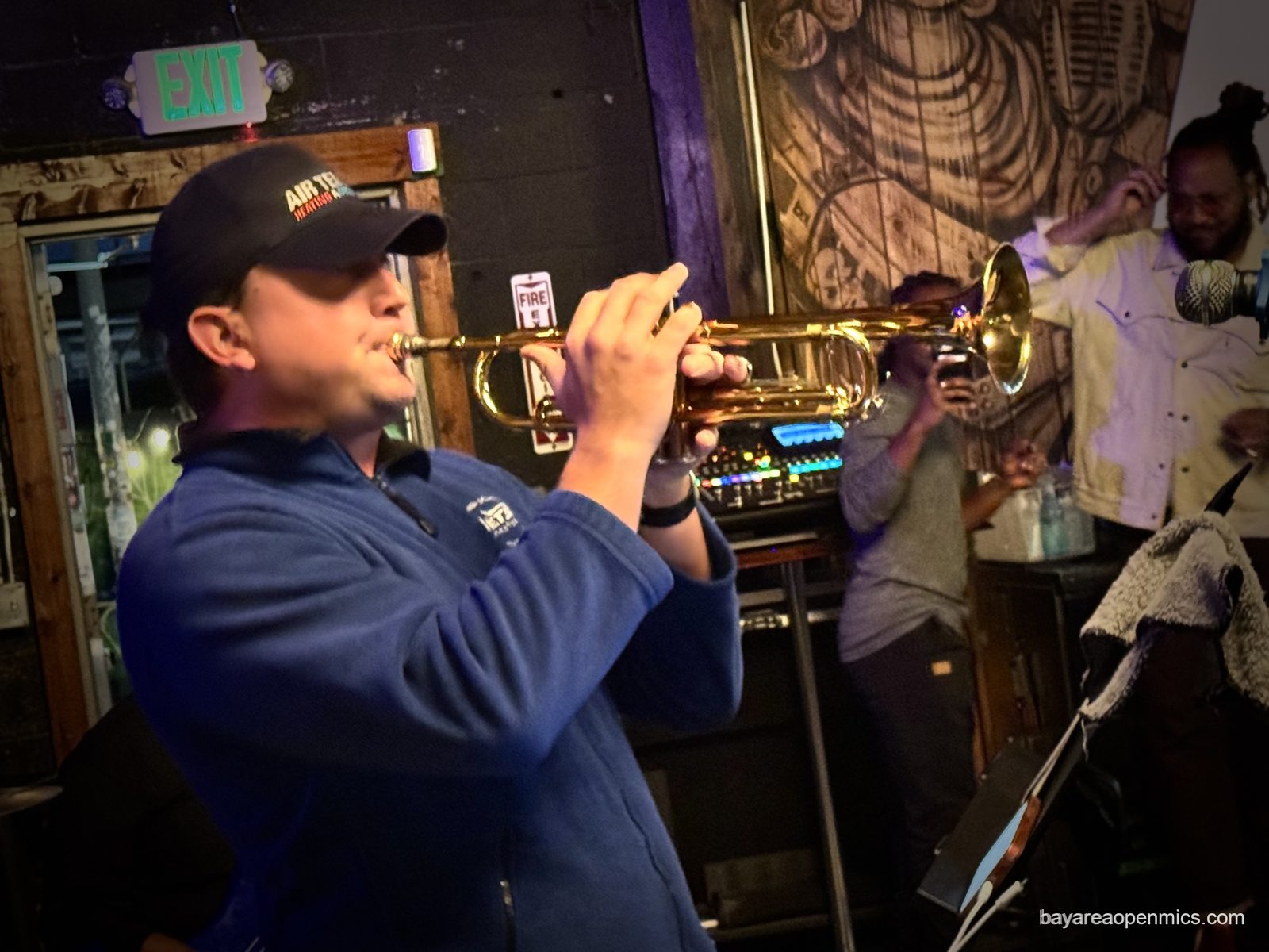 A trumpet player performs at the Fluid open mic at 7th West