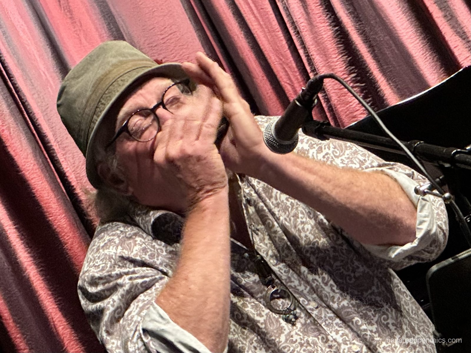 Jim Larsen plays harmonica at the Front Porch Music open mic