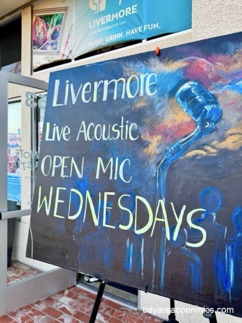 Hand-painted open mic sign in the window of Pinot's Palette in Livermore on a Wednesday evening