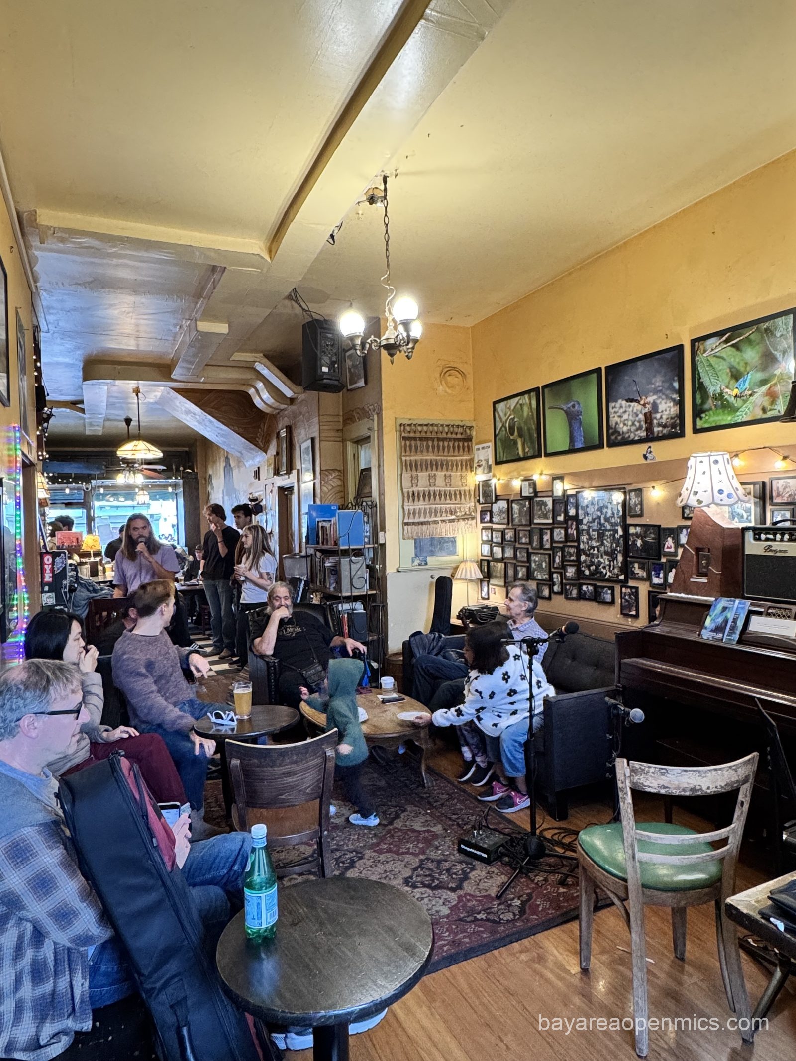 The MC announces the next open mic performer at Simple Pleasures Open Mic