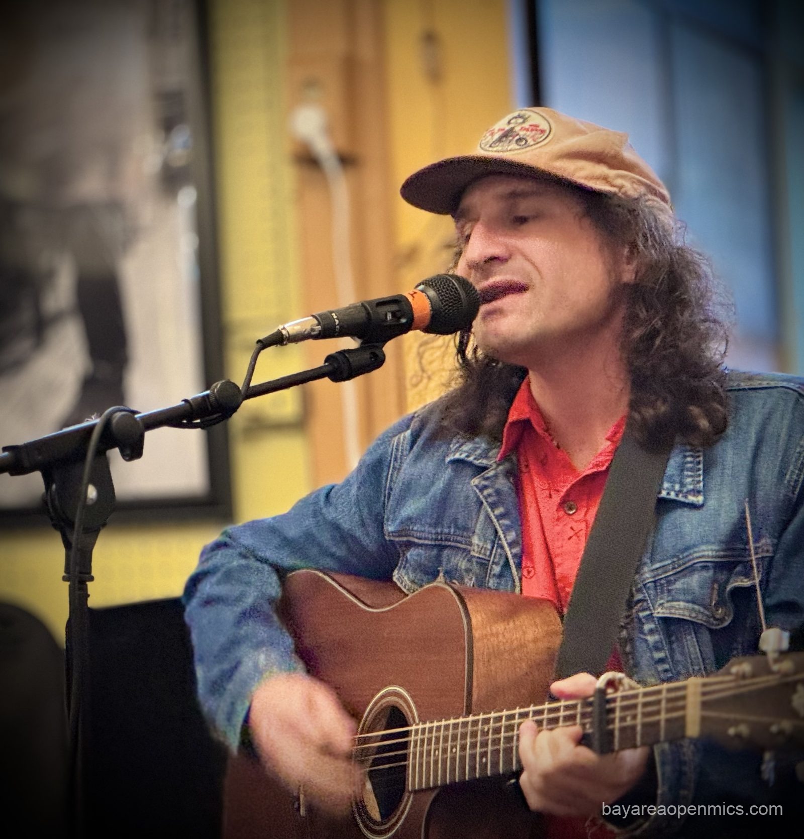 Little Oil performs on guitar at Simple Pleasures Open Mic in San Francisco
