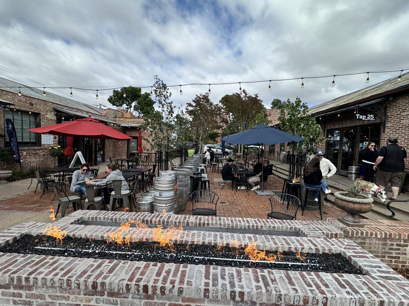 The firepit blazes on the brick plaza at Blacksmith Square outside Swirl on the Square in Livermore