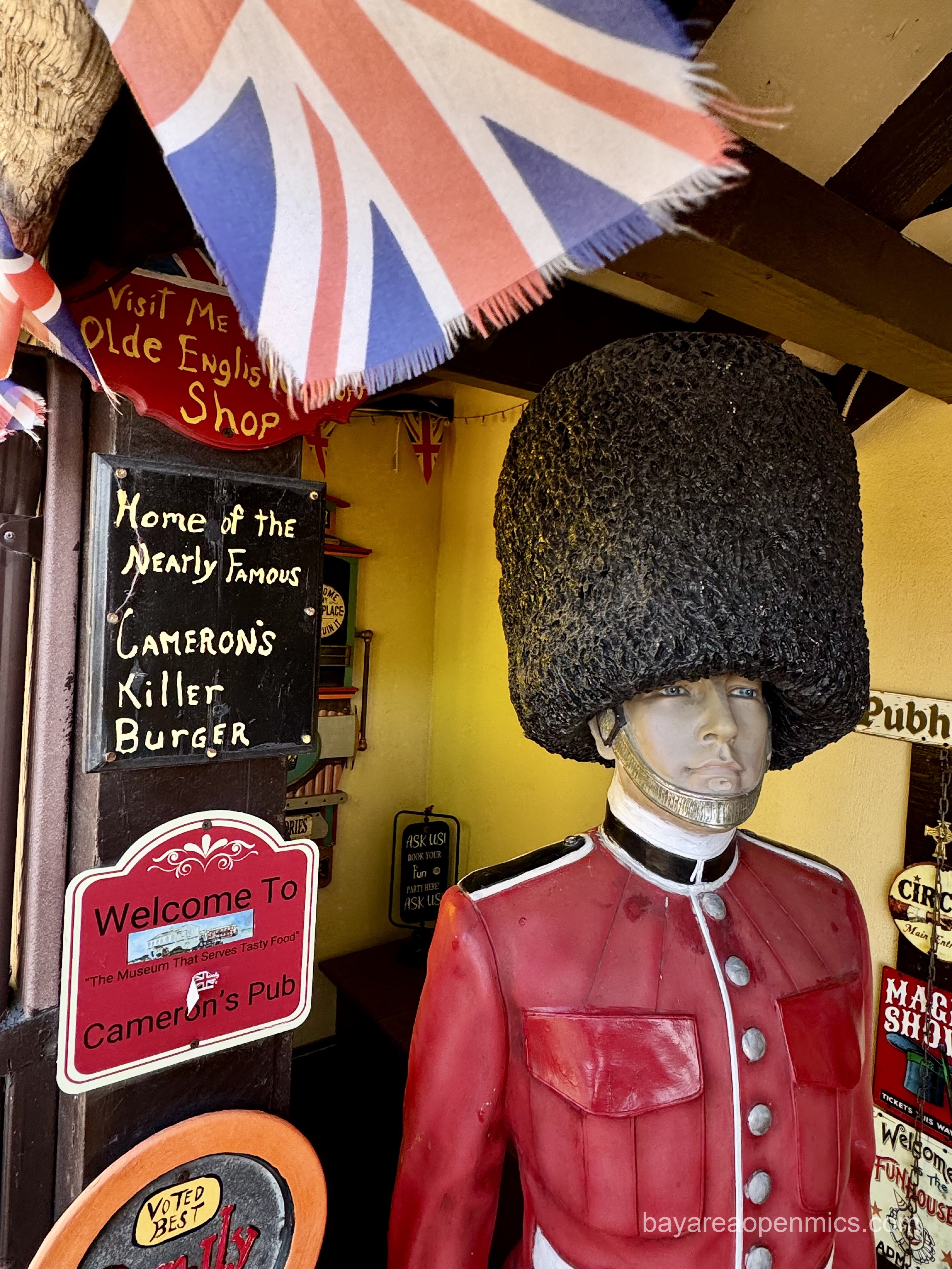 A mannekin in a British uniform wears a large furry beefeater hat