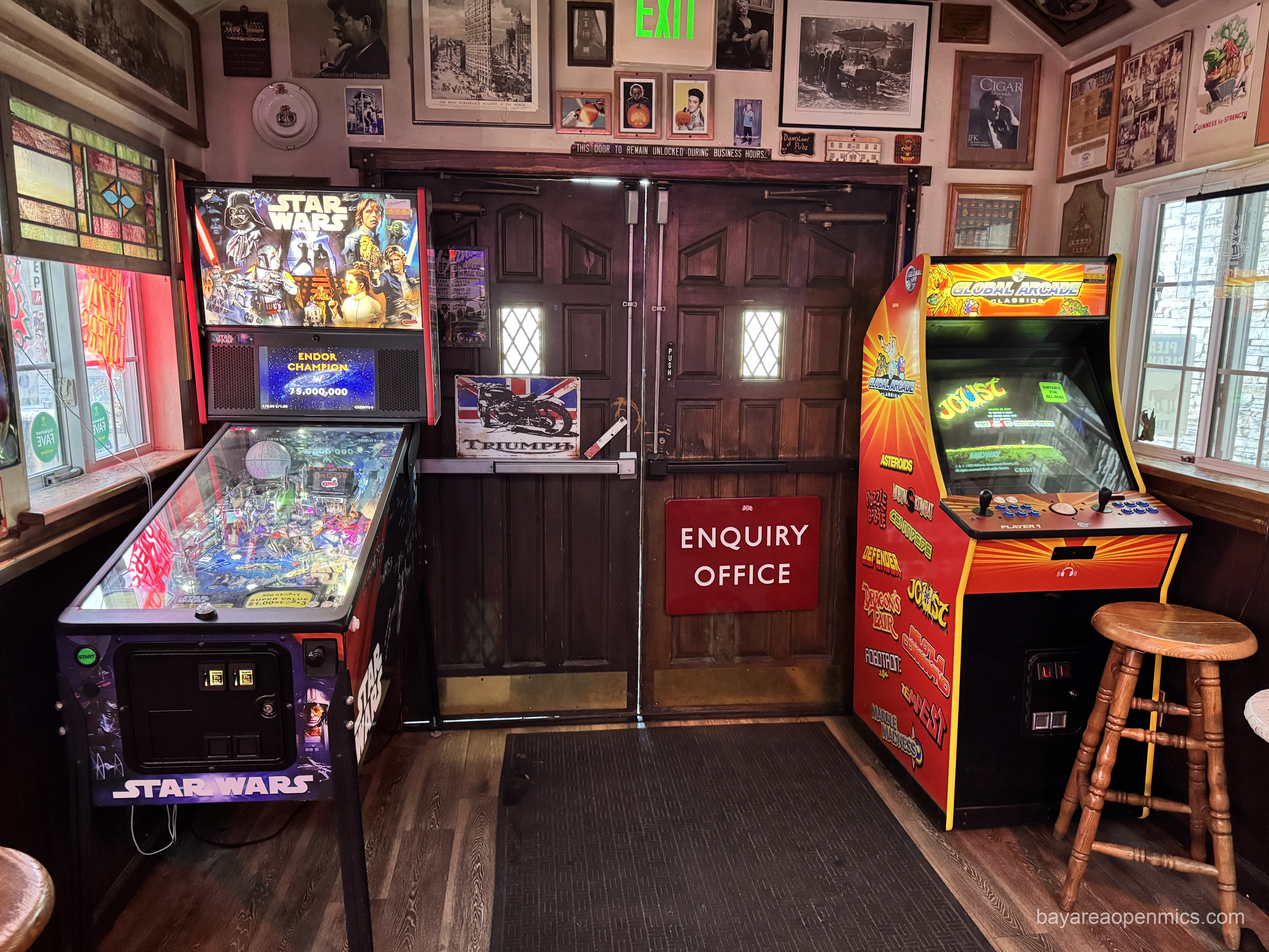 two arcade games flank the double exit doors