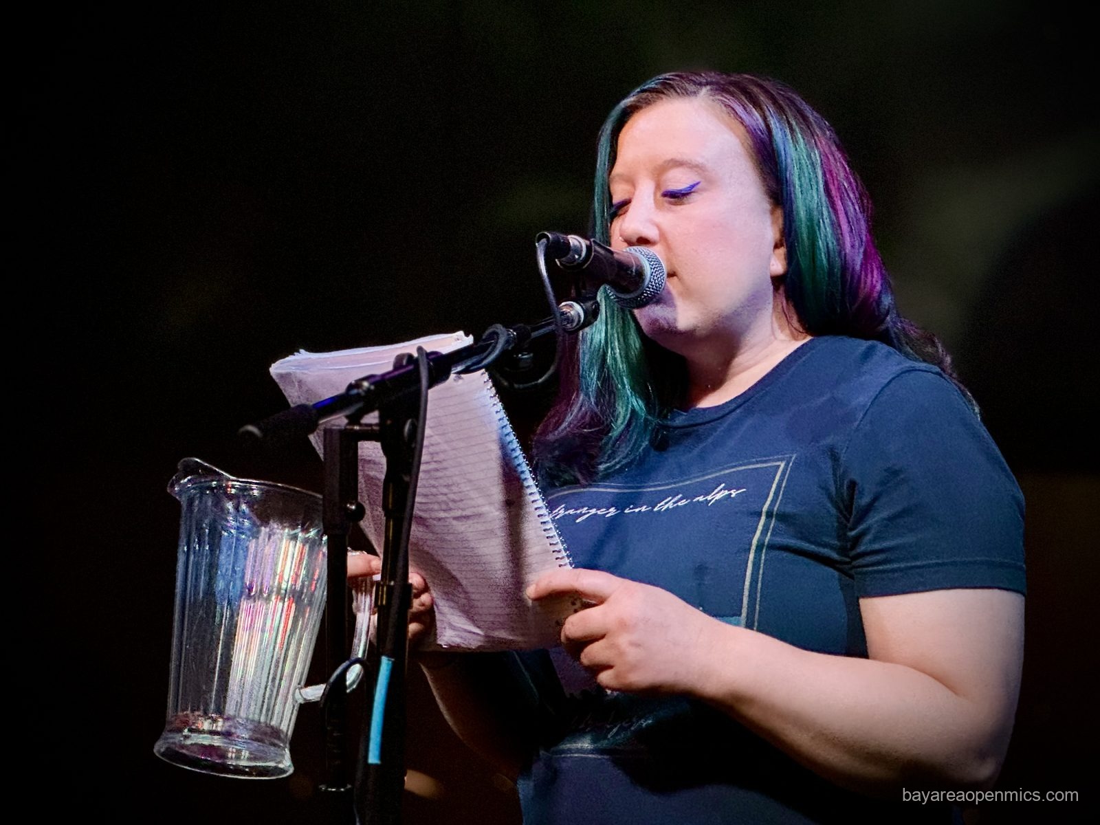 Carly Beltramo reads names from the beer pitcher at the Hotel Utah open mic