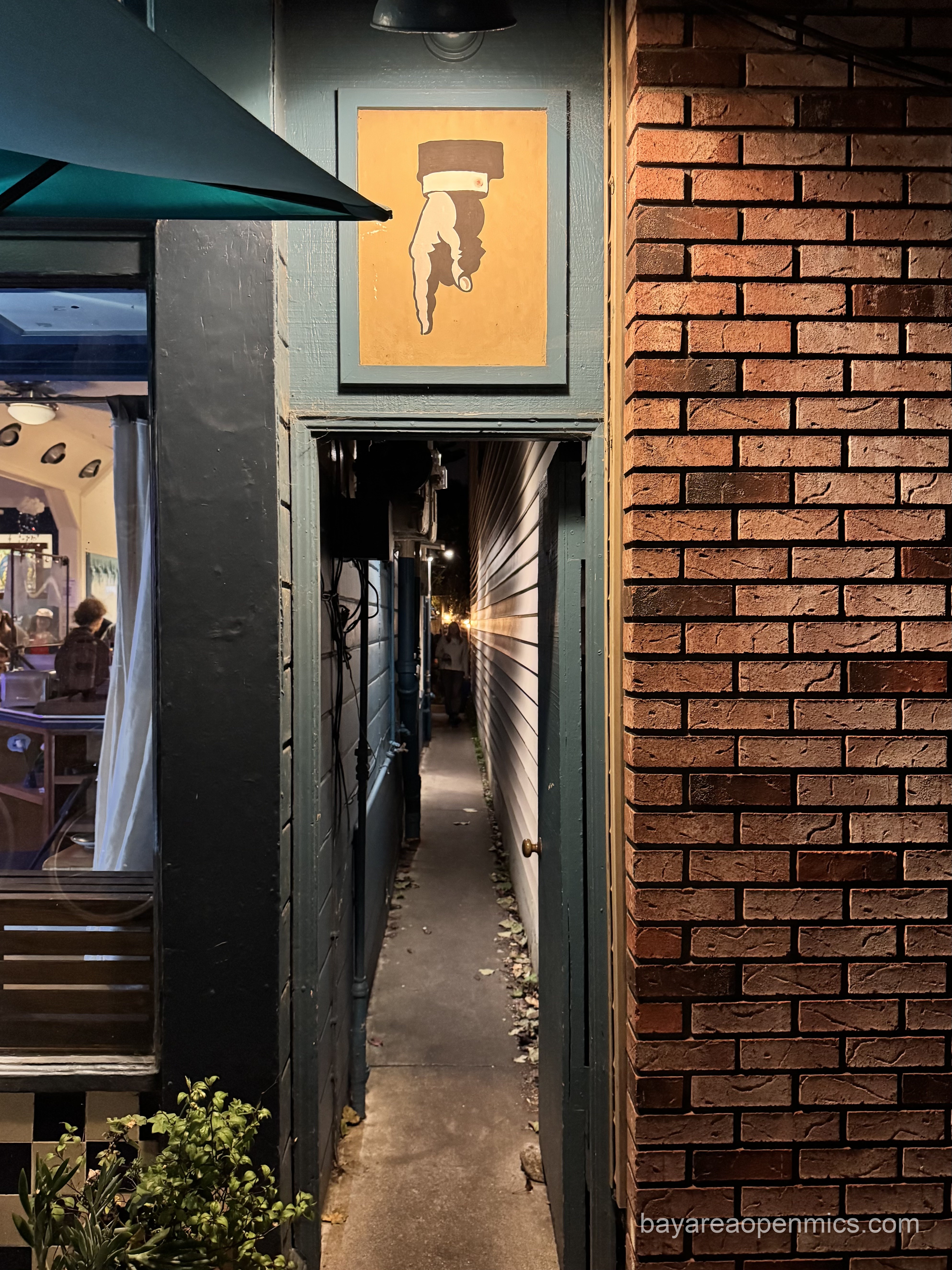 The finger of fate directs you into the iconic alleyway entrance to The Bazaar Cafe open mic